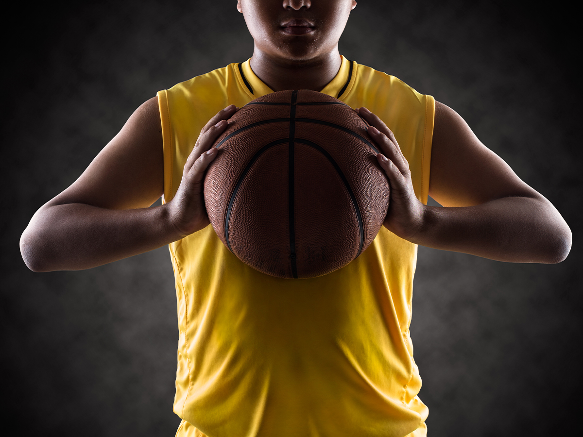 A teenage boy holding a basketball